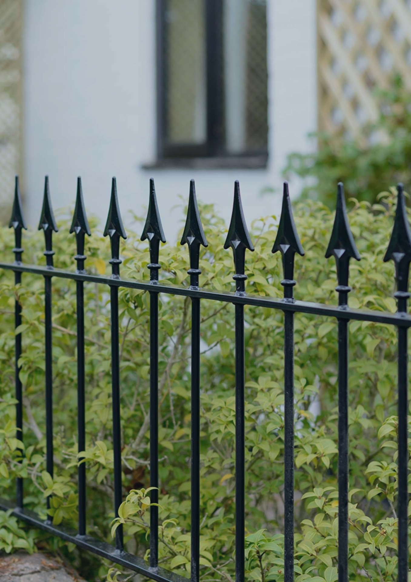 Wrought-iron fence with spear tips in front of an entrance
